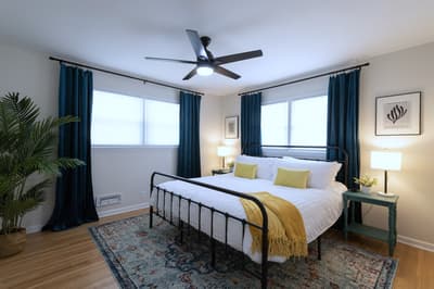 Drift off peacefully in your bright, airy bedroom with crisp linens and natural light streaming through dual windows.