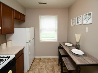 Your fully-equipped kitchen flows into a cozy dining nook, where natural light and warm finishes invite you to gather for home-cooked meals and easy mornings.