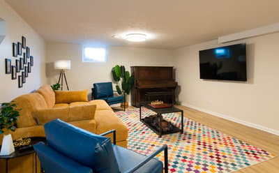 Sink into plush seating and enjoy movie nights by the fireplace in your cozy entertainment room.