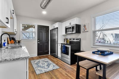 Cook your favorite meals in this modern kitchen featuring granite countertops, stainless steel appliances, and everything you need for a comfortable stay.