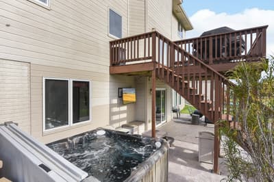 Soak your cares away in your private hot tub while enjoying the peaceful patio setting and tropical greenery.