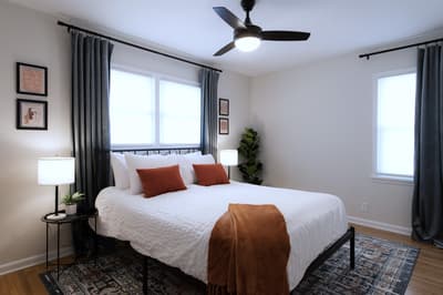 Rest peacefully in your cozy bedroom with crisp linens, warm accent pillows, and gentle ceiling fan comfort.