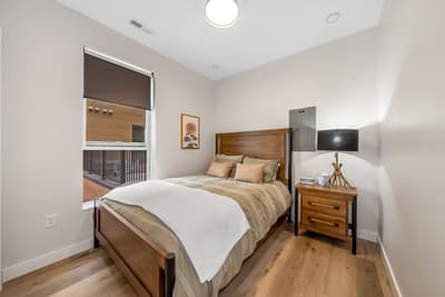 Drift into peaceful sleep in your cozy bedroom with warm wood tones and soft natural light.