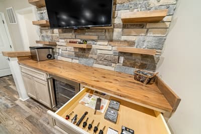 Your gourmet kitchen features warm wood countertops, stone accents, and modern appliances perfect for preparing memorable meals together.