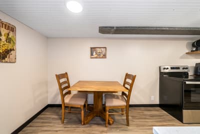 Gather around your cozy dining table for intimate meals in this warm, well-appointed space with rustic charm and modern conveniences.