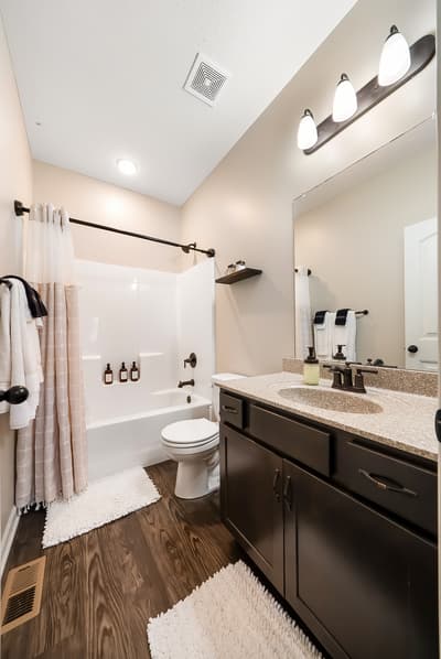 Refresh in your modern bathroom featuring a soaking tub, granite countertops, and plush towels for total comfort.