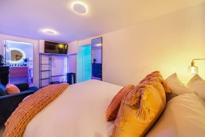 Unwind in your stylish bedroom where warm ambient lighting and plush textiles create the perfect sanctuary for restful nights.