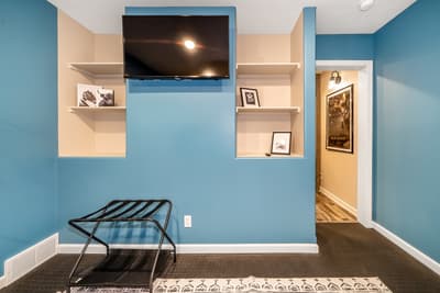 Unwind in your private entertainment space with wall-mounted TV and cozy seating for perfect evening relaxation.