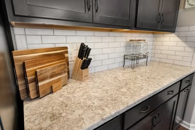 You'll love cooking in this modern kitchen with granite countertops, subway tile backsplash, and quality knife block for your culinary adventures.