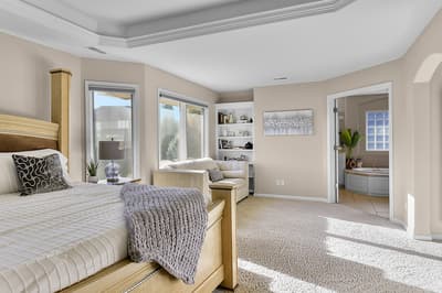 Sink into your spacious master suite featuring a cozy reading corner and thoughtfully designed layout perfect for relaxation.