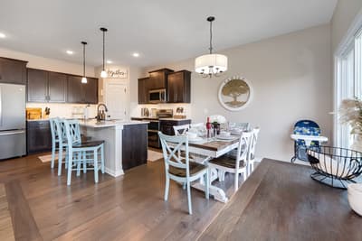 Your open-concept kitchen flows into the dining area, where you'll gather around the rustic table for memorable meals together.