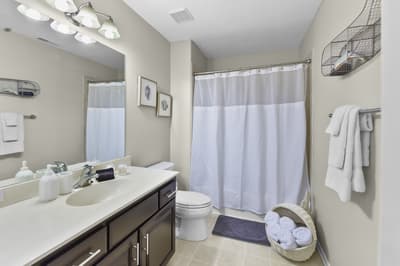 Freshen up in your spacious bathroom with gleaming counters, soft lighting, and plush towels waiting for you.