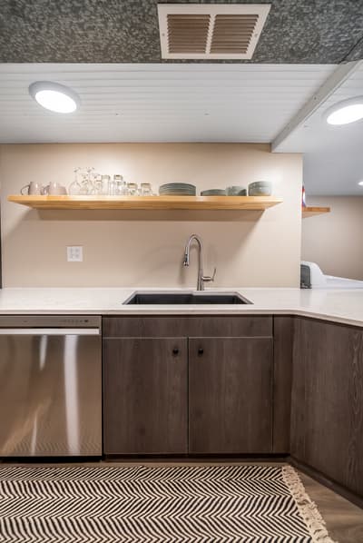Your sleek kitchen features warm wood shelving, stainless steel appliances, and everything you need for memorable meals together.