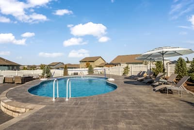 Dive into your private oasis with this sparkling pool surrounded by comfortable loungers and shade umbrellas.