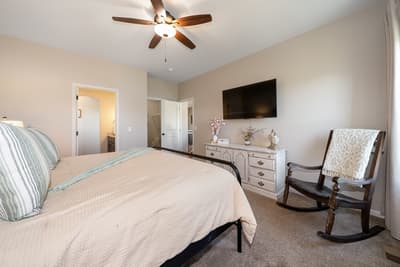Sink into your comfortable bed while the ceiling fan creates a gentle breeze. Cozy rocking chair awaits your morning coffee moments.