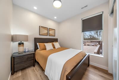 Sink into this cozy bedroom where soft lighting and warm tones create your perfect retreat after exploring the day.