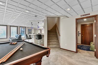Your private game room awaits with pool table, bar seating, and cozy entertainment space for memorable evenings.