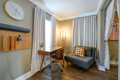 Find your productivity flow in this stylish workspace, where natural light streams through elegant curtains onto your modern desk.