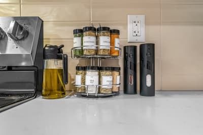 Your kitchen comes equipped with a thoughtful spice rack featuring rosemary, oregano, and essential seasonings to elevate your home-cooked meals.