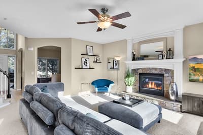 Unwind in your elegant living room with cozy sectional seating and crackling fireplace, perfect for relaxing evenings.
