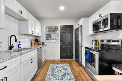 Your bright, modern kitchen awaits with granite counters and stainless steel appliances for culinary adventures.