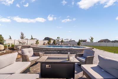 Relax in your private outdoor oasis with plush seating around the stunning raised pool and spacious patio.