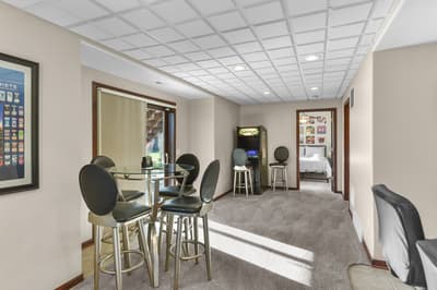 Unwind in this spacious game room with Galaga arcade, high-top dining, and comfortable seating—your perfect retreat for entertainment and relaxation.