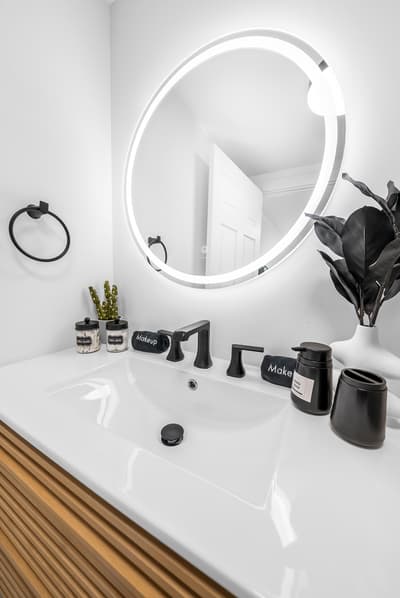 Your stylish bathroom features a sleek illuminated mirror and modern fixtures, creating a spa-like atmosphere for your daily routine.