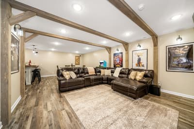 Sink into your private entertainment haven with plush leather seating, rustic beams overhead, and a wet bar for movie nights.