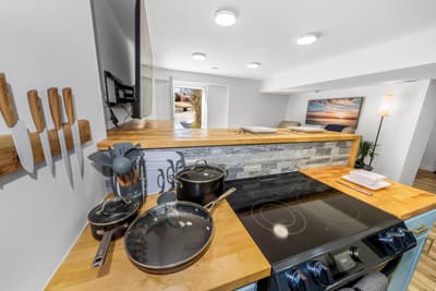 Cook memorable meals in your fully equipped kitchen with premium appliances and warm wood countertops.