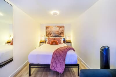 Drift into peaceful sleep in your cozy bedroom with warm lighting, artistic touches, and modern comforts.