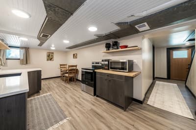 Your fully equipped kitchen features modern appliances and a cozy dining nook, perfect for preparing meals and enjoying intimate dinners together.