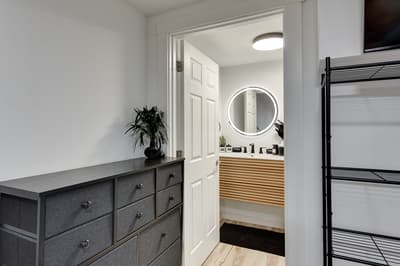Your ensuite bathroom awaits with a luxurious illuminated mirror and spa-like vanity, perfect for your morning routine.