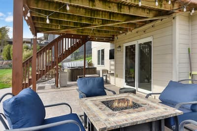 Gather around your private fire table under twinkling lights, perfect for evening conversations with hot tub soaks just steps away.