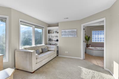 Sink into this plush sofa and let the stunning mountain views through floor-to-ceiling windows create your perfect relaxation retreat.