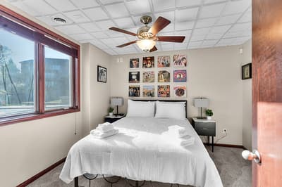 Rest comfortably in your music-themed bedroom, featuring crisp linens, vintage album artwork, and a ceiling fan for perfect temperature control.
