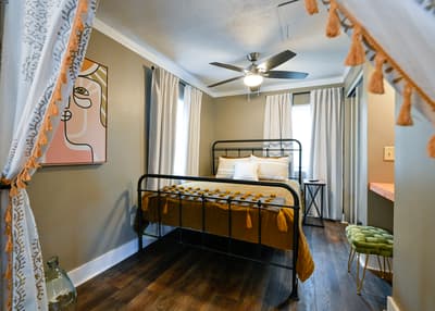 Slip into your dreamy bedroom with boho-chic touches and natural light streaming through flowing curtains.