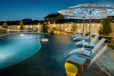 Step into your private evening oasis with a sparkling pool, comfortable loungers, and ambient lighting creating the perfect atmosphere for relaxation.