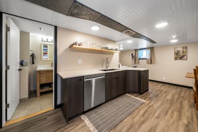 Your modern basement kitchen features sleek dark cabinets, stainless appliances, and everything you need for comfortable meal prep.