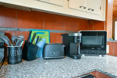 Your fully equipped kitchen features modern appliances including a microwave, toaster, and coffee maker for convenient meal preparation.
