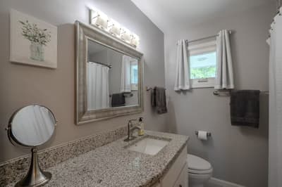 Step into your private bathroom featuring granite countertops, elegant lighting, and thoughtful touches that make your daily routine feel luxurious.