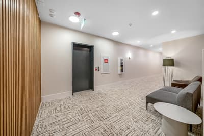 Relax in the modern lobby area with comfortable seating while waiting for the elevator to your room.