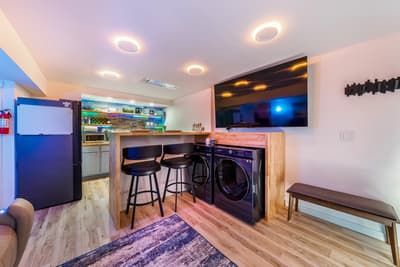 Your modern basement retreat features a full kitchen, breakfast bar, entertainment center, and convenient laundry facilities—perfect for extended stays.