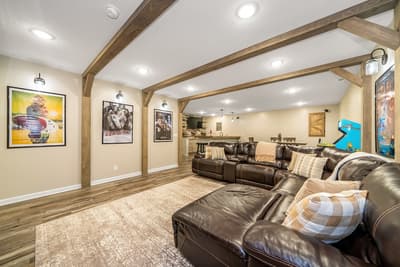 Sink into plush leather seating beneath rustic wood beams in your entertainment haven, complete with vintage movie posters and arcade games.